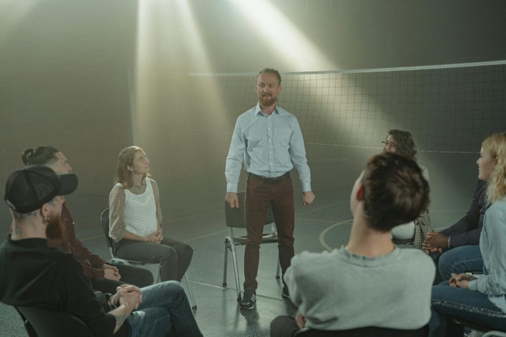A supportive group therapy session in a sunlit room, highlighting connection and healing.